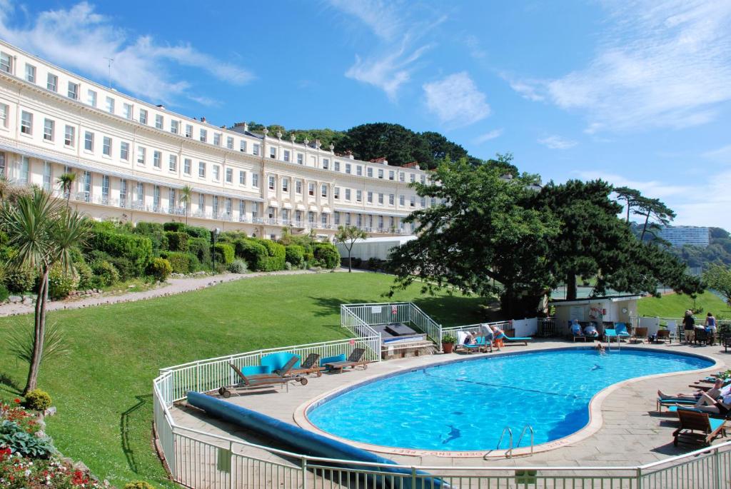 a large swimming pool in front of a building at The Osborne Hotel in Torquay