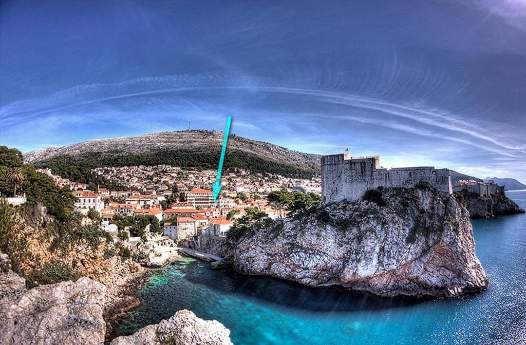 a castle on top of a rock in the water at Veranda Rooms in Dubrovnik