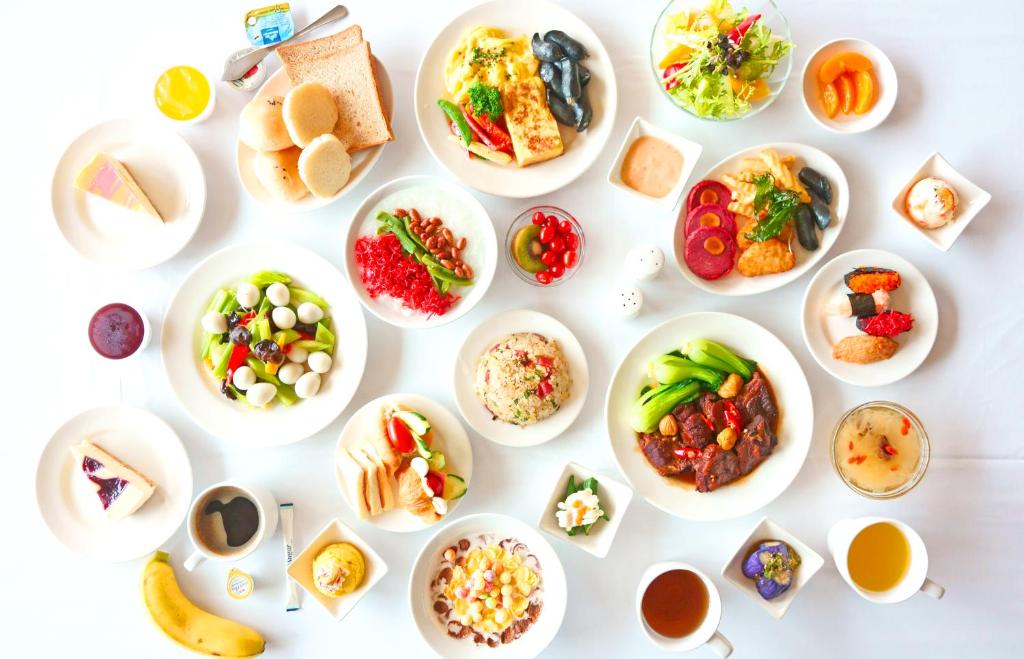 a white table with plates of food on it at Jia Hsin Garden Hotel in Tainan