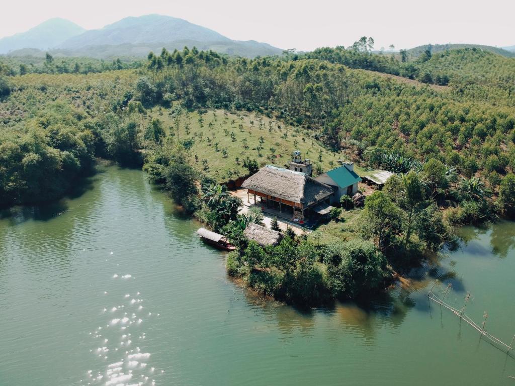 
a large body of water surrounded by trees at Vu Linh Farmstay in Yên Bình

