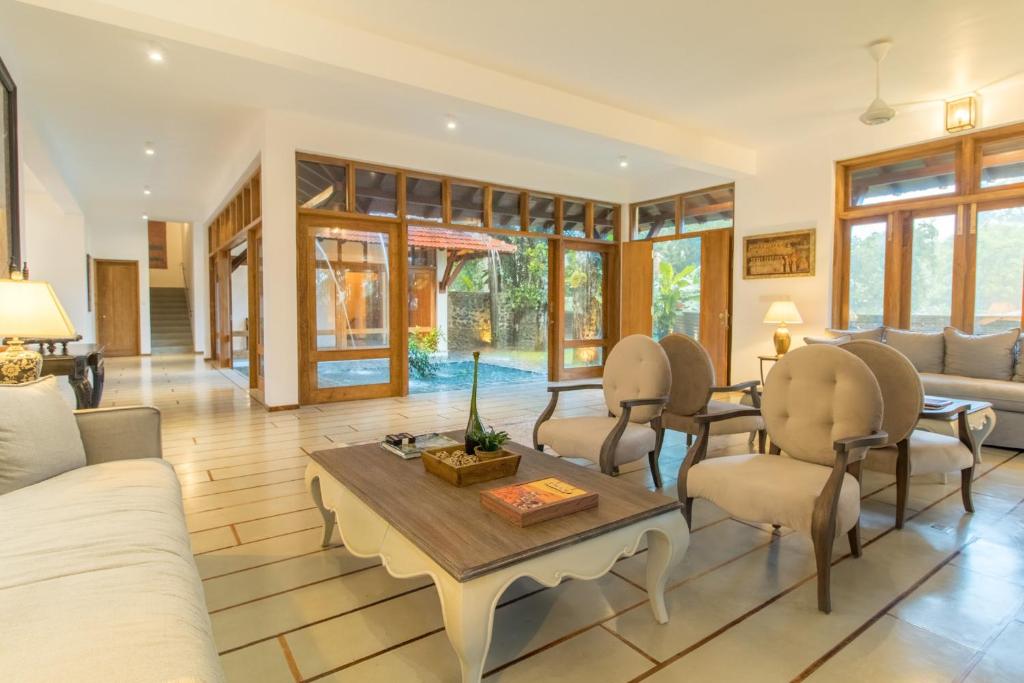 - un salon avec une table et des chaises dans l'établissement Niketh Villa Kandy, à Kandy