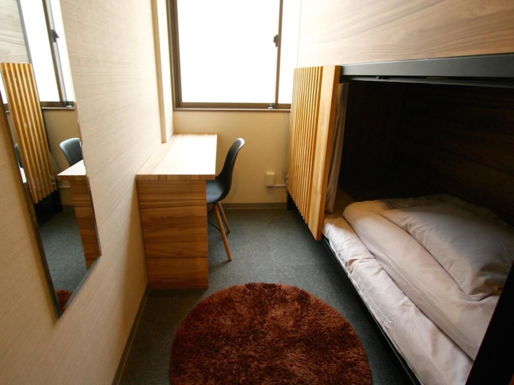 Postel nebo postele na pokoji v ubytování Namba Guesthouse HIVE