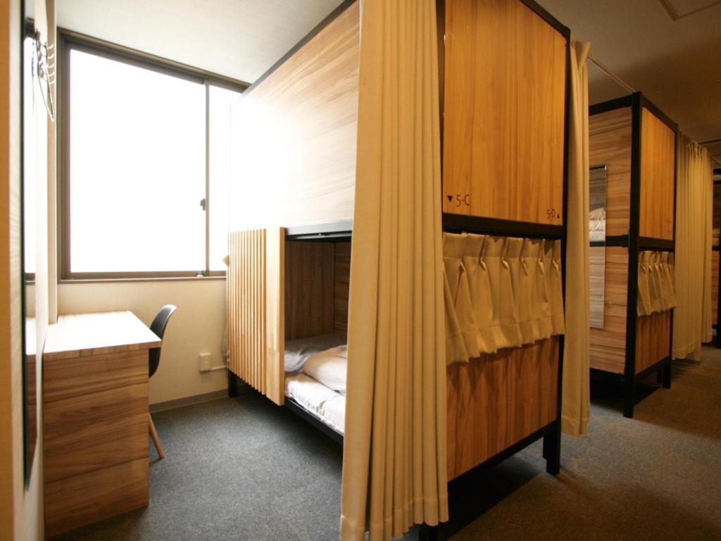Postel nebo postele na pokoji v ubytování Namba Guesthouse HIVE