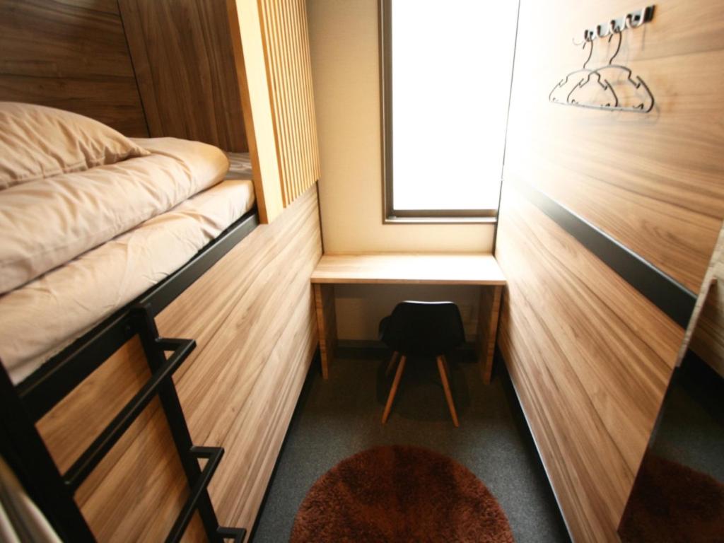 Postel nebo postele na pokoji v ubytování Namba Guesthouse HIVE