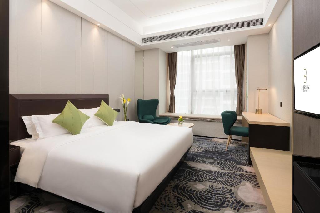Postel nebo postele na pokoji v ubytování Buddy Hotel-Free Shuttle to Canton Fair Complex during Canton Fair Period