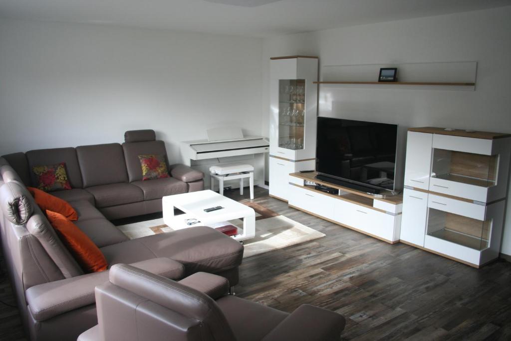 a living room with a couch and a piano at Privat Unterkunft Schreiber in Winterbach
