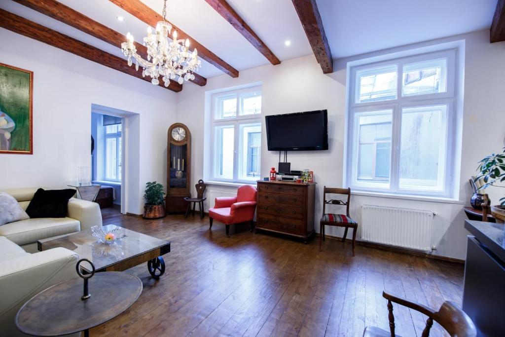 a living room with a couch and a tv at Old Town Kalēju Street in Rīga