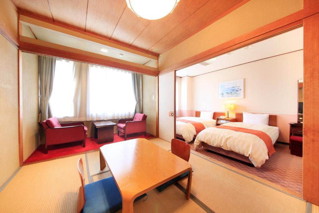 Postel nebo postele na pokoji v ubytování Fuji Green Hotel