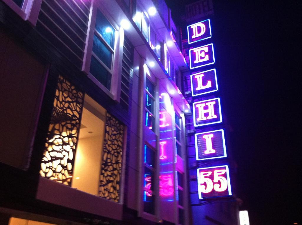 a lit up sign on the side of a building at HOTEL DELHI 55 @ NEW DELHI RAILWAY STATION in New Delhi