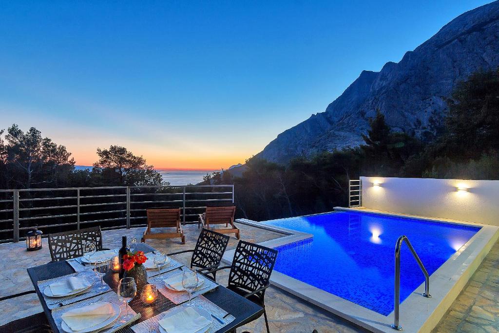 a patio with a table and a swimming pool at Holiday home Sergio in Bast