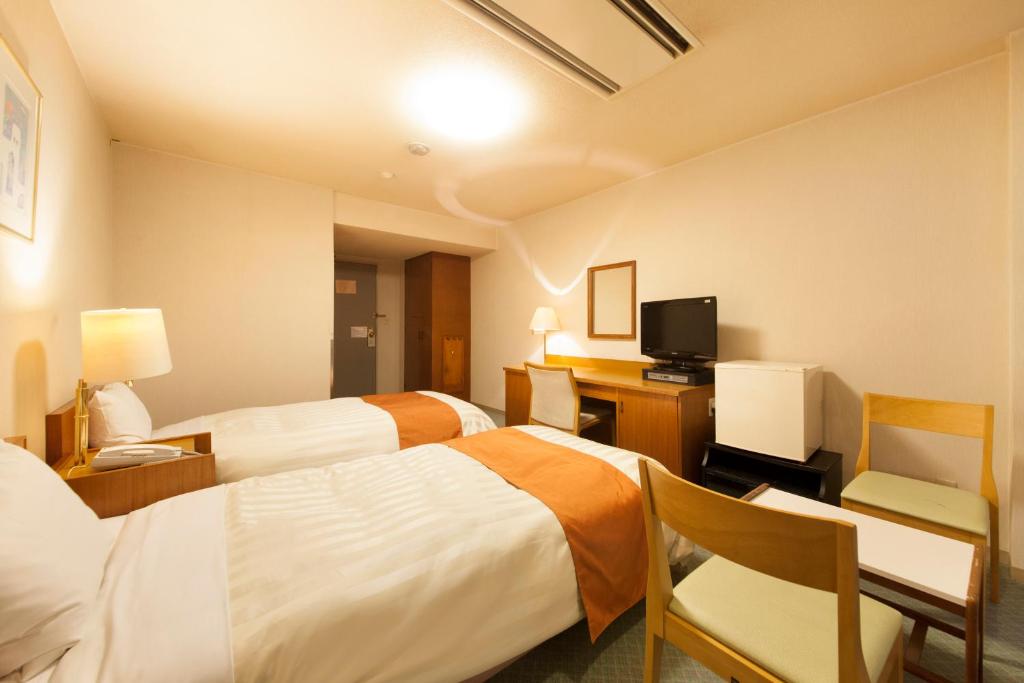 Postel nebo postele na pokoji v ubytování Fuji Green Hotel