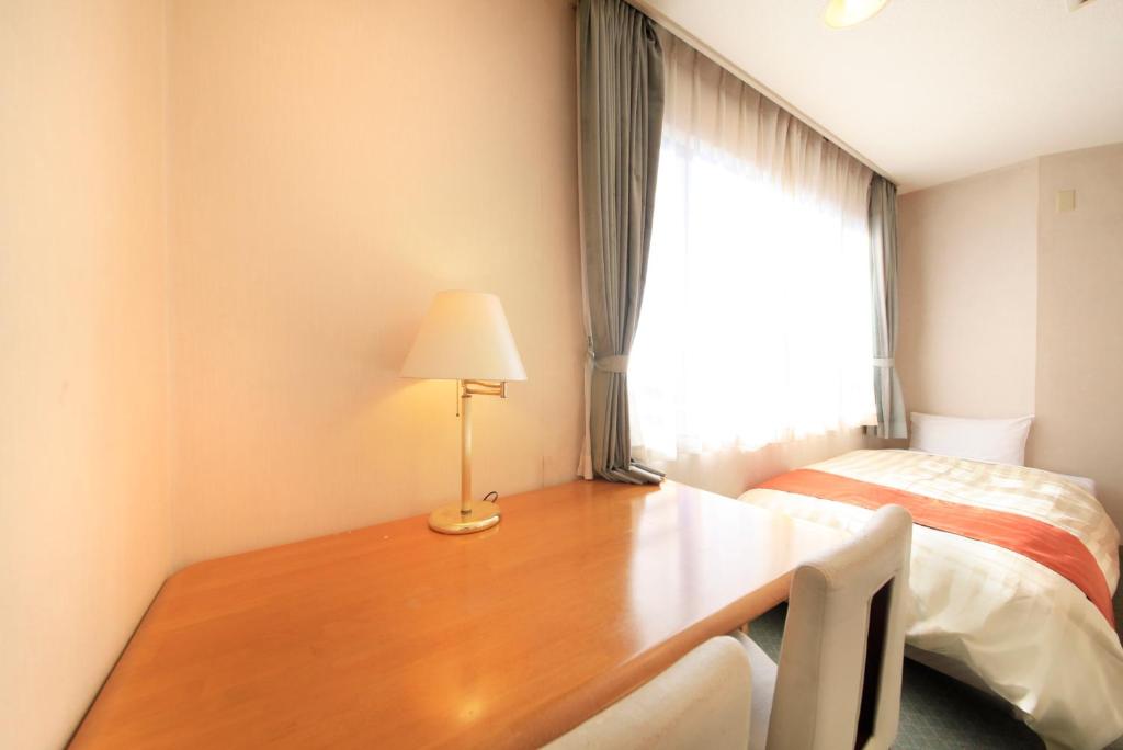 Postel nebo postele na pokoji v ubytování Fuji Green Hotel