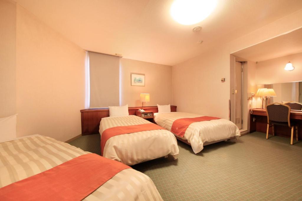 Postel nebo postele na pokoji v ubytování Fuji Green Hotel