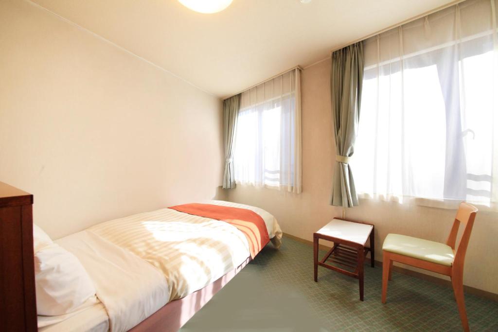 Postel nebo postele na pokoji v ubytování Fuji Green Hotel