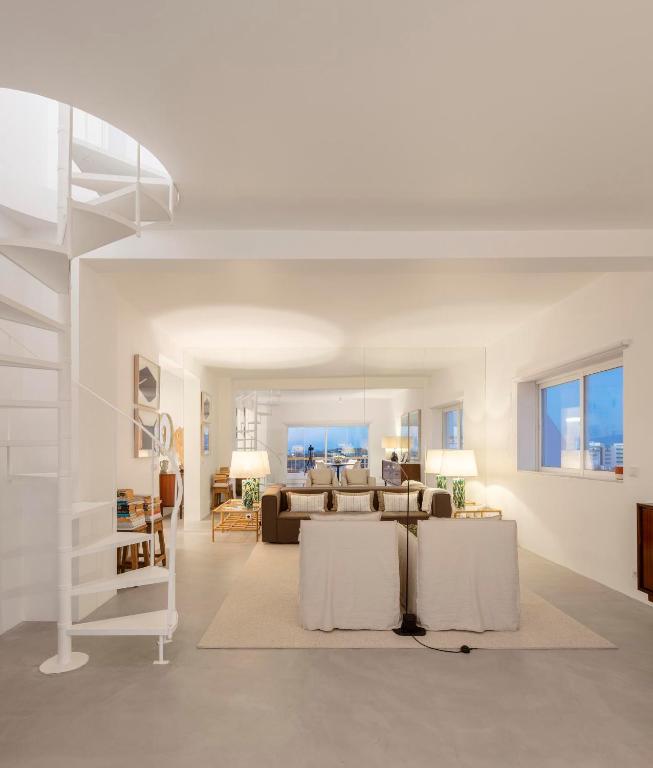 a living room with a couch and a table at LUXURY ALVOR PENTHOUSE in Alvor