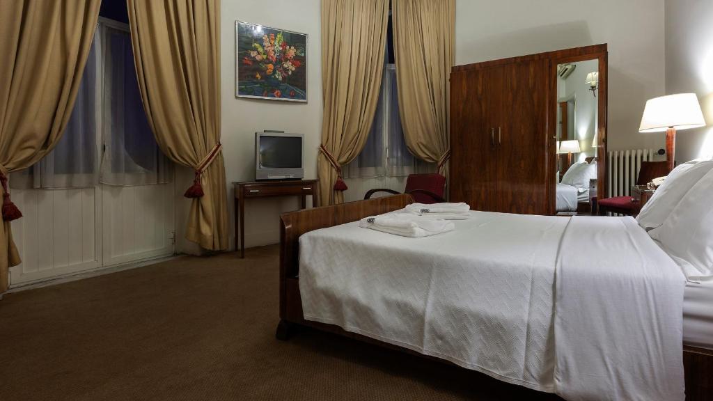 Postel nebo postele na pokoji v ubytování Hotel Astoria