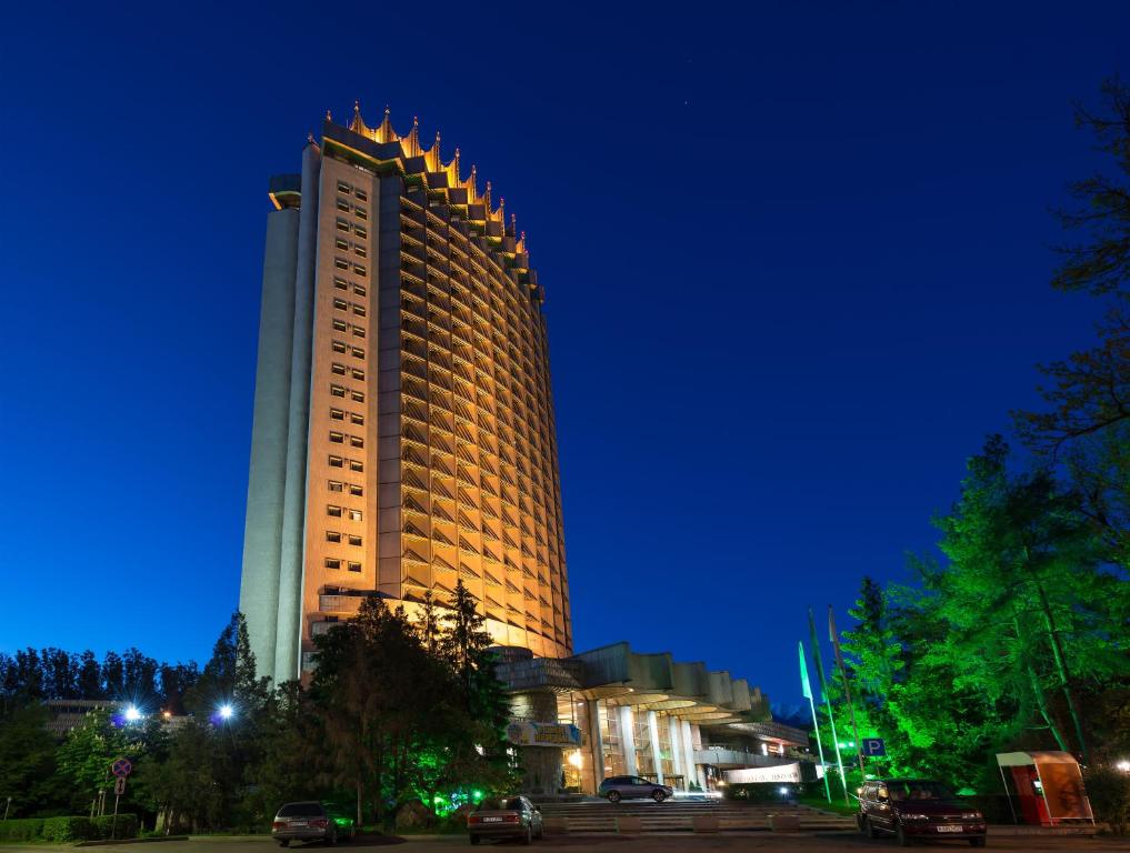 a large building is lit up at night at Kazakhstan Hotel in Almaty