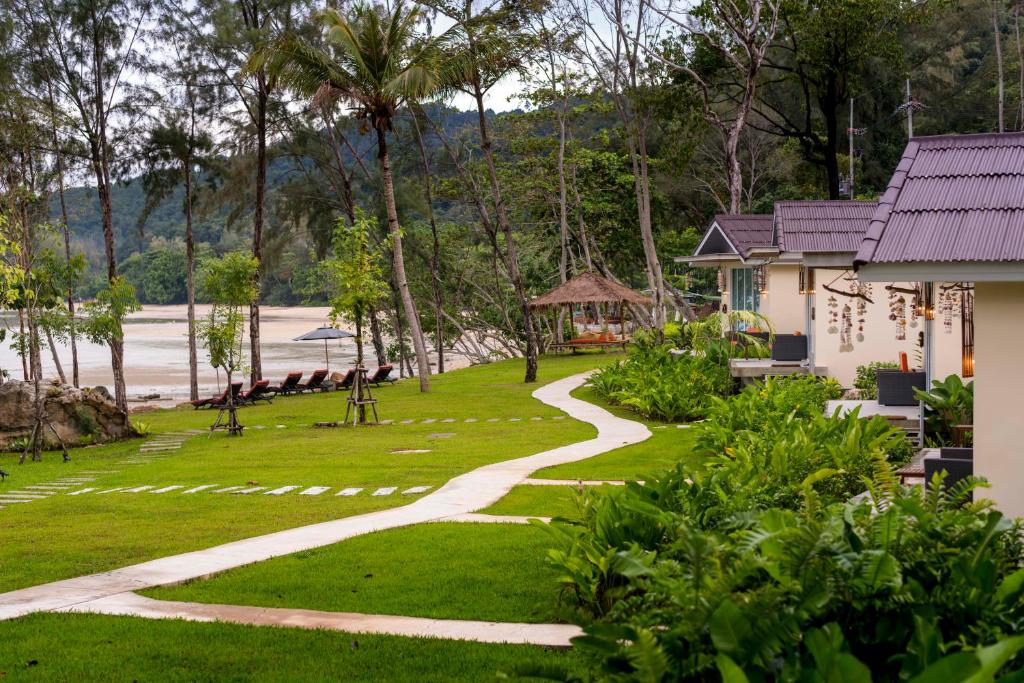 a walkway leading to a house next to a beach at Krabi Home Resort in Tab Kaek Beach