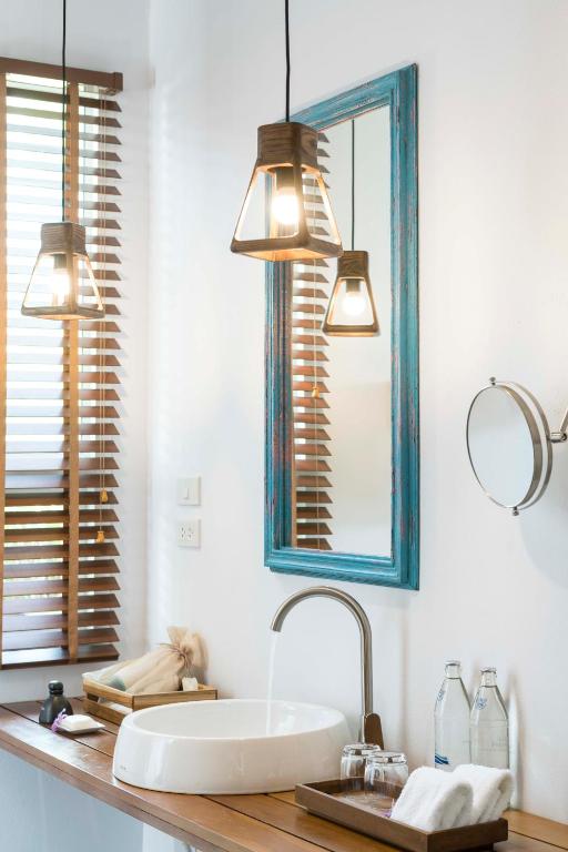a bathroom with a sink and a mirror at Krabi Home Resort in Tab Kaek Beach