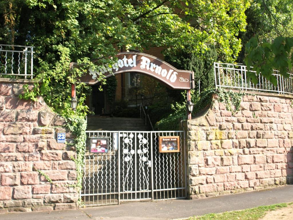 a gate with a sign that reads world rumpus at Hotel Villa Arnold in Bad Kissingen