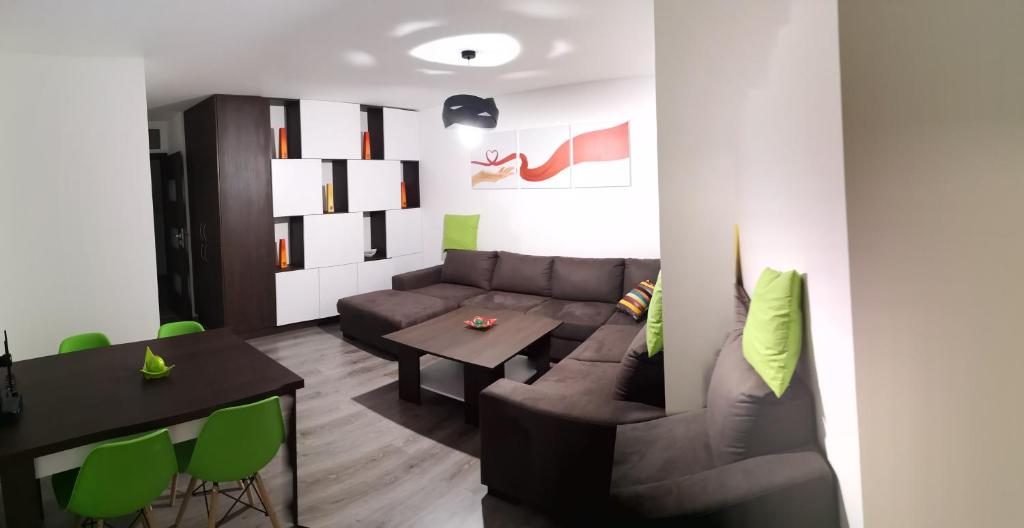 a living room with a couch and a table at Centrum Apartman LEYLA in Bardejov