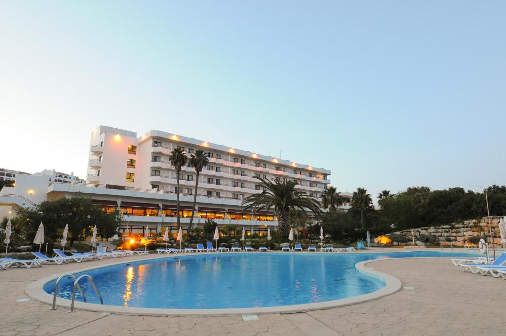 a large swimming pool in front of a hotel at INATEL Albufeira in Albufeira