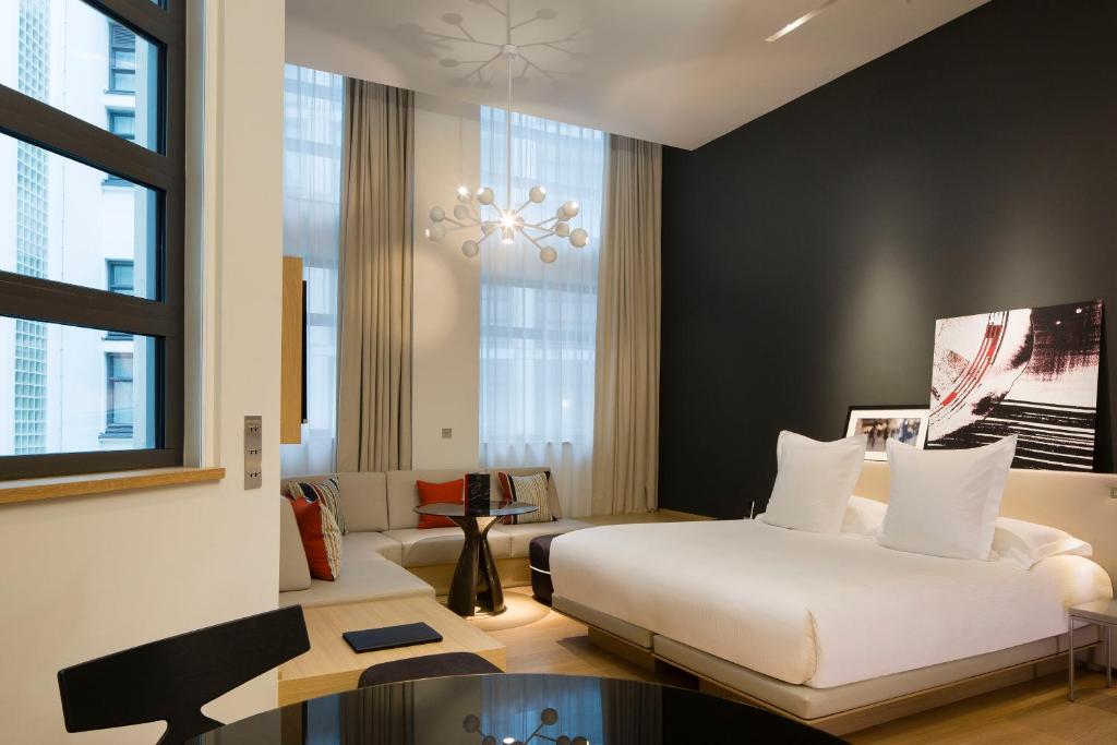 a hotel room with two beds and a table at Le Cinq Codet in Paris
