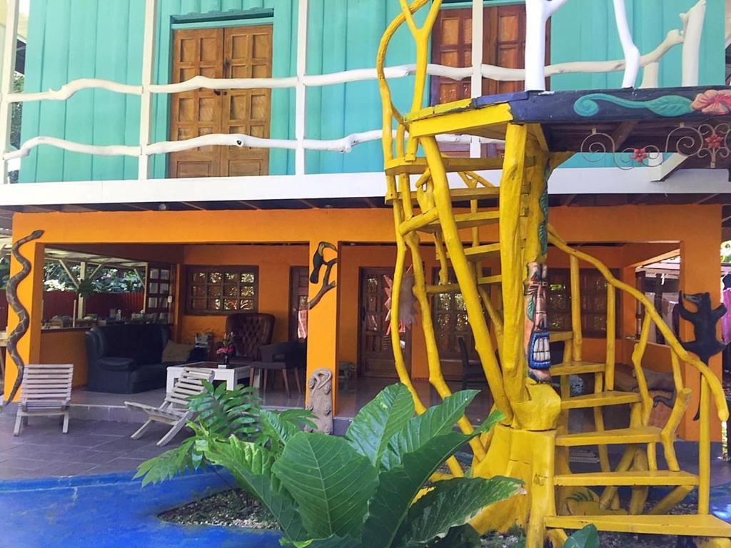 uma escada amarela está do lado de um edifício em Madre Selva Hostel em Puerto Viejo