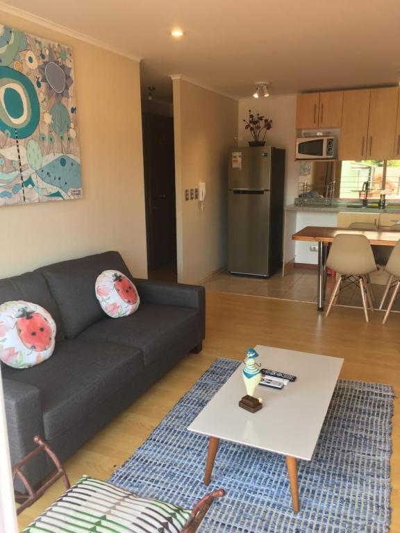 a living room with a couch and a table at Centrico departamento en Pucon in Pucón