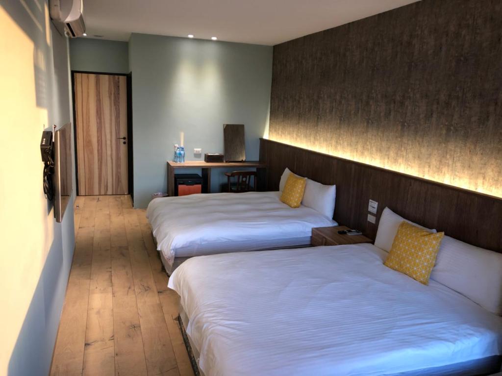 Postel nebo postele na pokoji v ubytování Jiufen HappyLand B&B