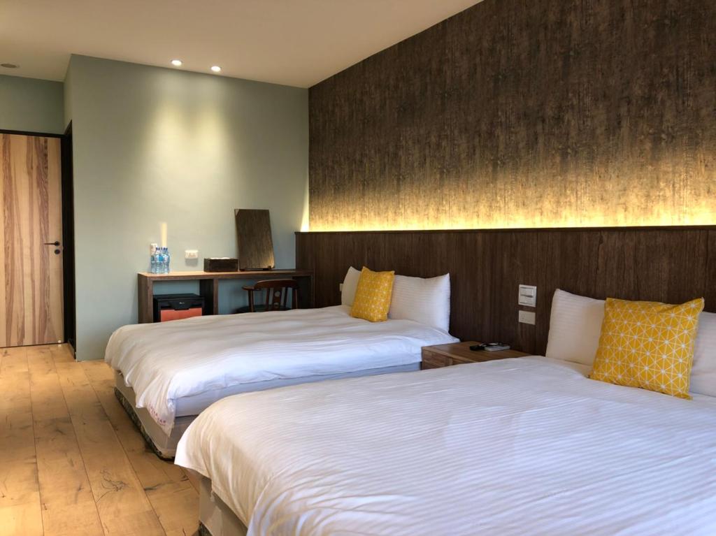 Postel nebo postele na pokoji v ubytování Jiufen HappyLand B&B