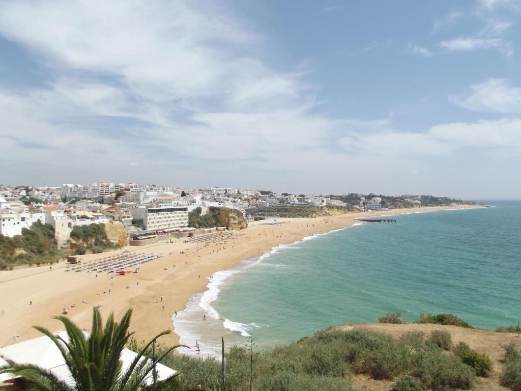 a view of a beach with people in the water at Frentomar in Albufeira