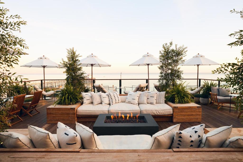 a patio with a couch and a fire pit at The Surfrider Malibu in Malibu