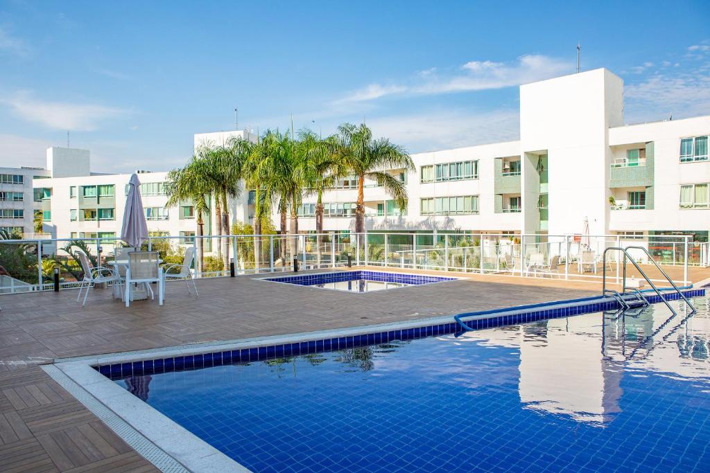 a swimming pool in front of a building at Premier Residence in Brasília