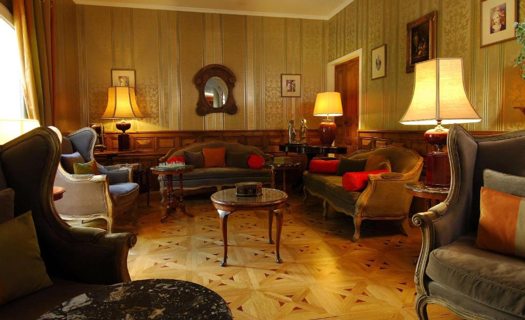 a living room with couches and chairs and a table at Best Western L&#39;Orangerie in Nîmes