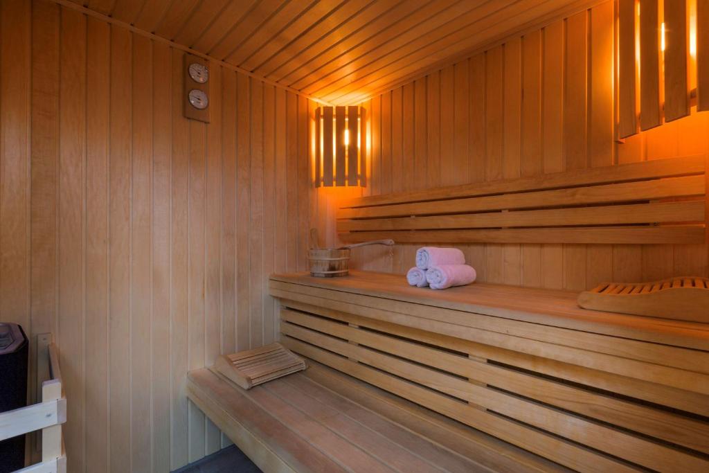 a sauna with a pink towel and a stuffed animal at Best Western Les Bains Hotel et SPA in Perros-Guirec