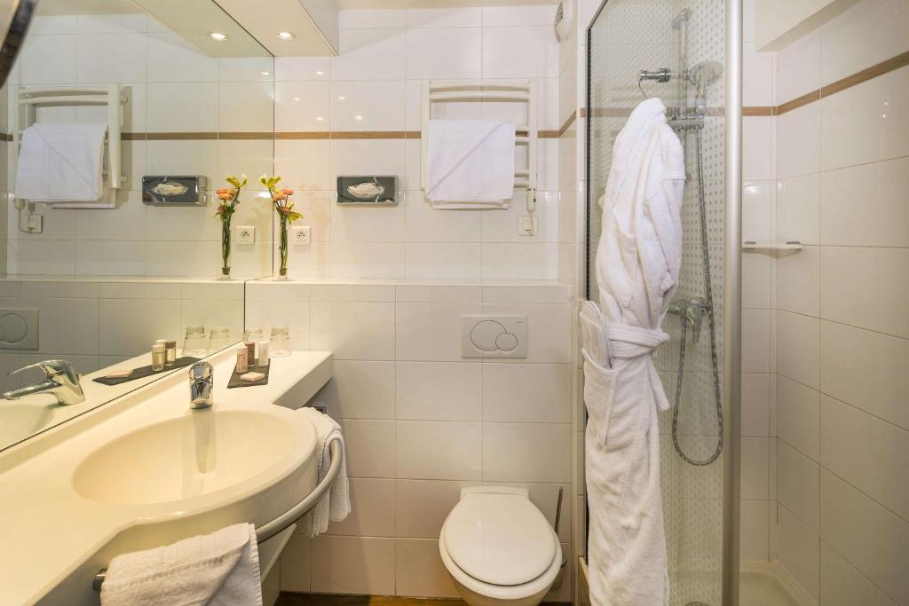 a bathroom with a sink and a toilet and a shower at Best Western PLUS Elixir Grasse in Grasse