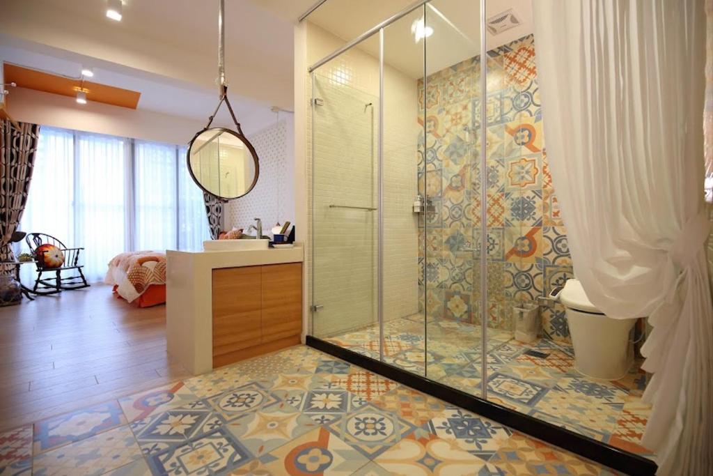 a bathroom with a shower with a glass door at 321 Apartment B&amp;B in Hualien City