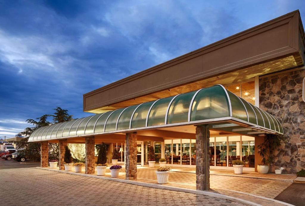 a building with a glass roof on a street at SureStay Plus Hotel by Best Western Brandywine Valley in Wilmington