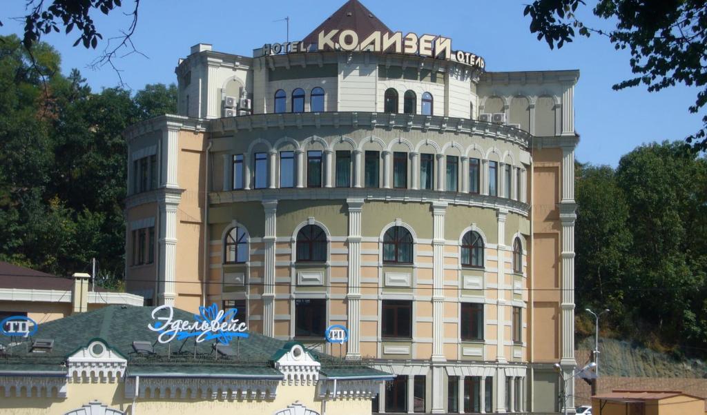 a building with a sign on top of it at Kolizey Hotel in Kislovodsk