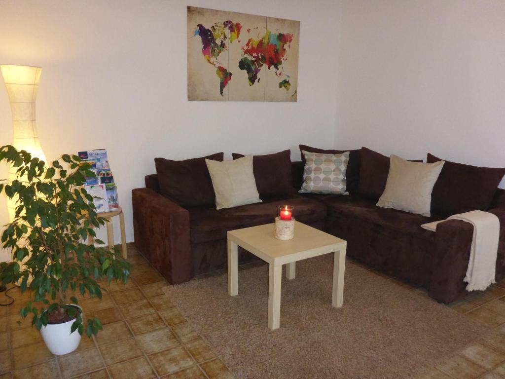 a living room with a couch and a table with a candle at Ferienwohnung Weyl in Eschbach