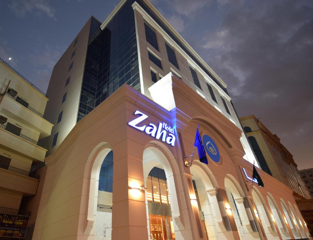 a building with a kia dealer sign on it at Zaha Al Munawara Hotel in Al Madinah