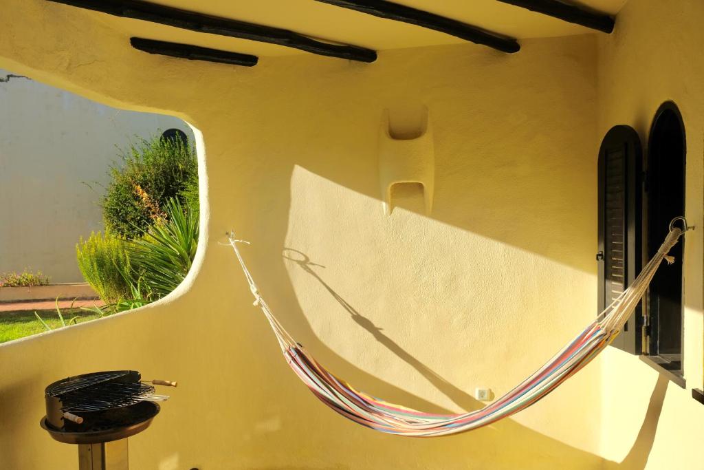 a hammock hanging on the side of a wall at Peaceful & Spacious Apt with Parking & Queen Bed in Carvoeiro
