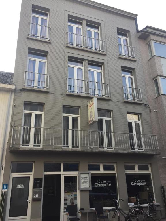 
a building with a large window on the side of it at Hotel Chaplin in Blankenberge
