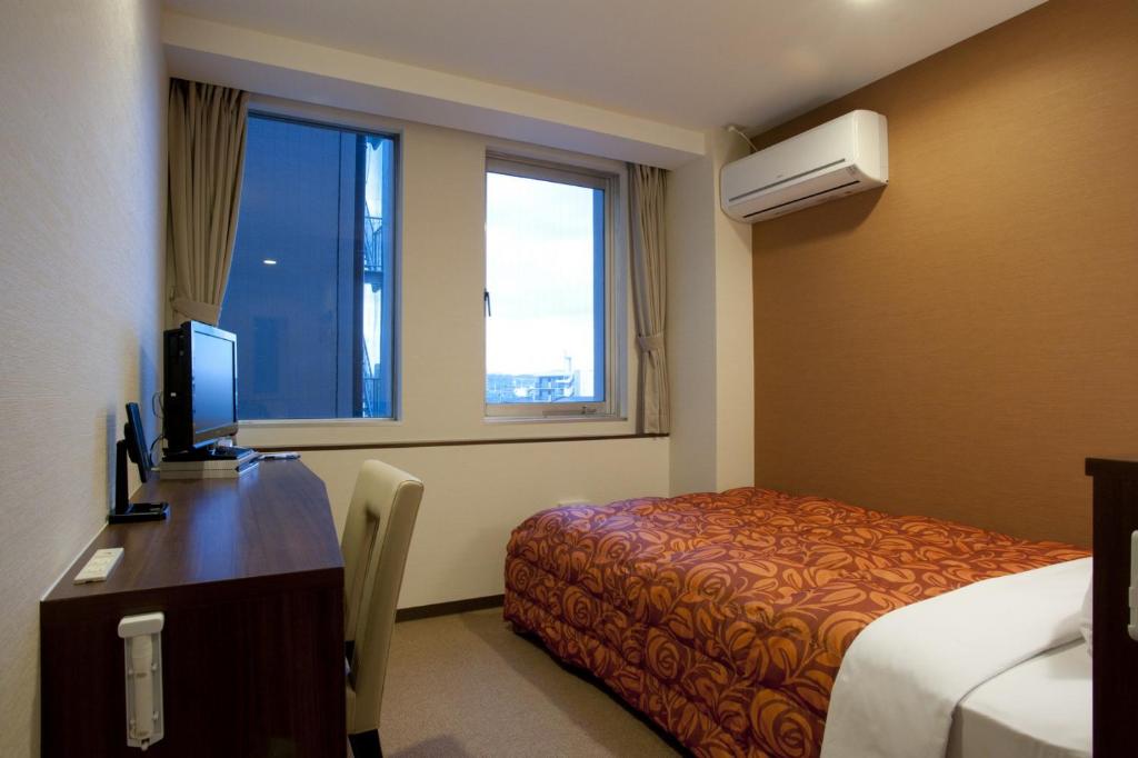 เตียงในห้องที่ Hotel Kudou Oita