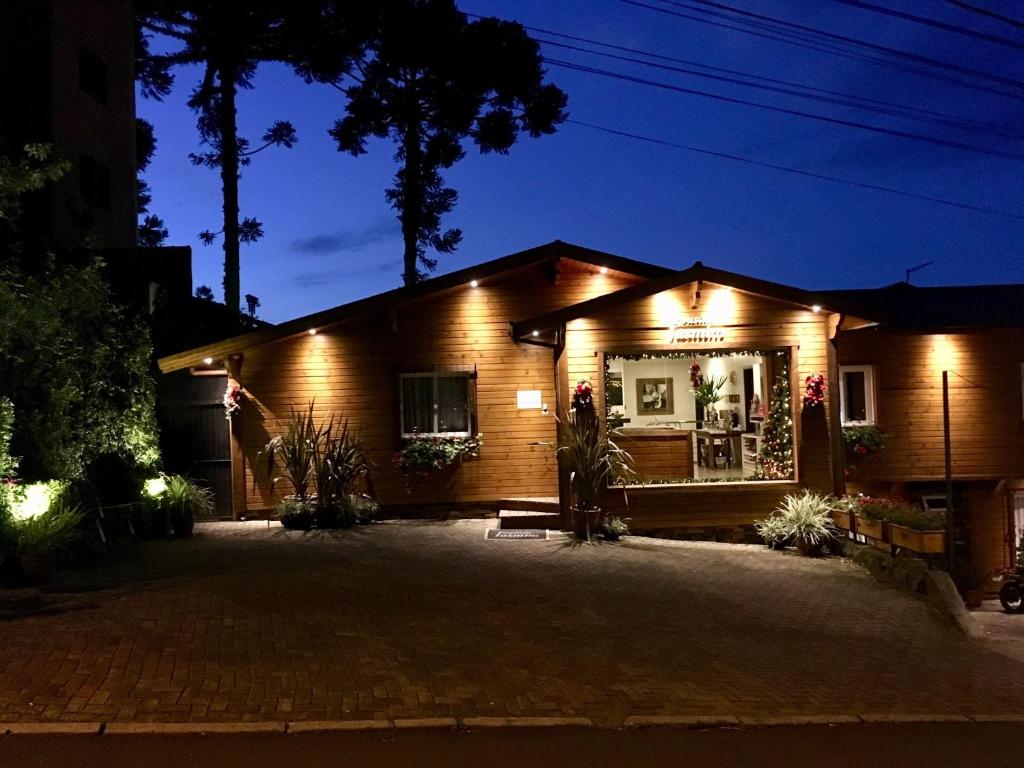 a house with lights on it at night at Pousada Jasmim in Gramado