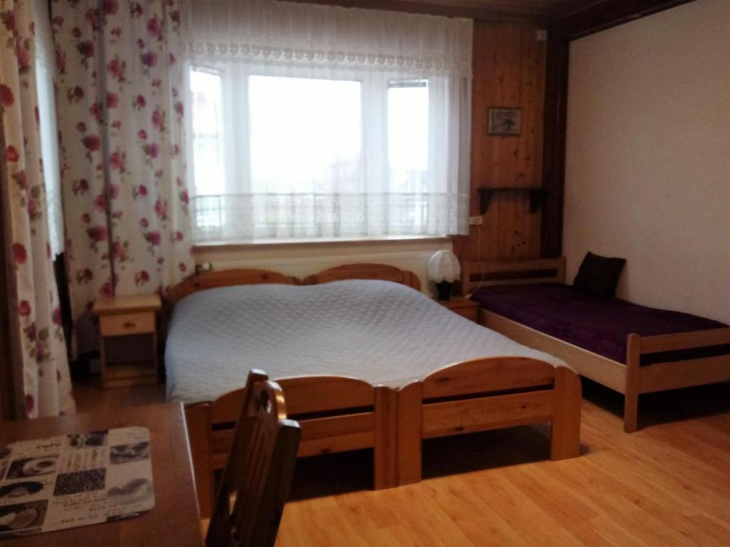 Posteľ alebo postele v izbe v ubytovaní Pokoje PETRA pod Bocianem