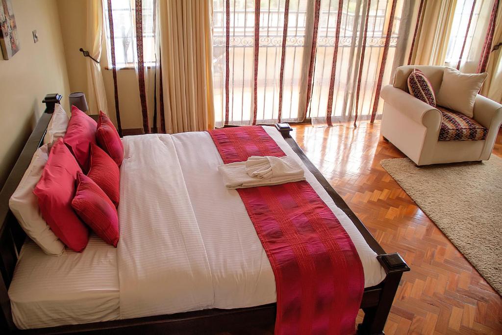 Postel nebo postele na pokoji v ubytování Orchid Homes, Gigiri
