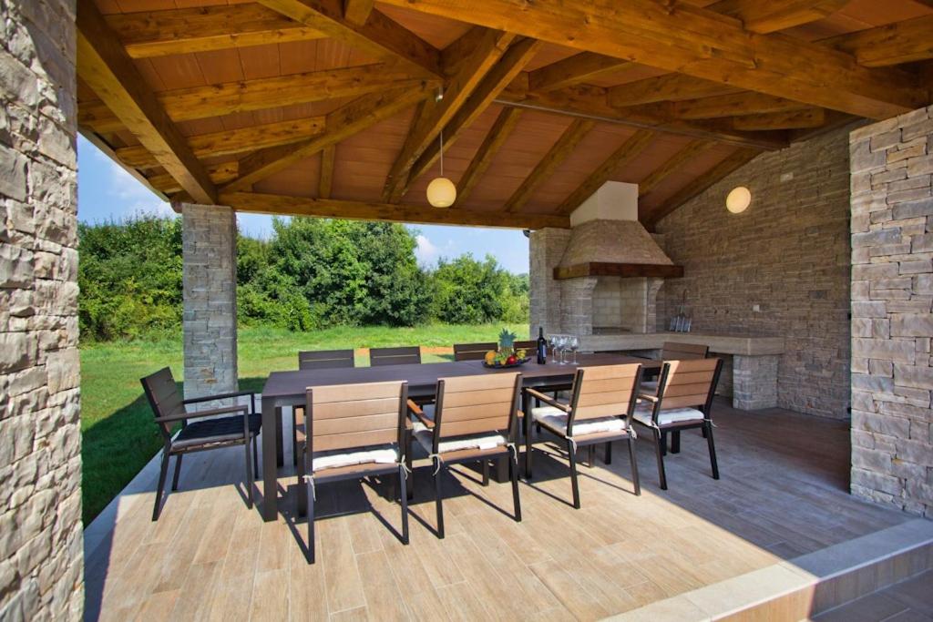 an outdoor dining area with a table and chairs at Villa Mattina in Nedeščina