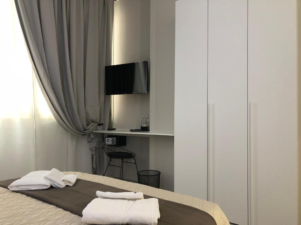 sypialnia z łóżkiem z ręcznikami w obiekcie Turin Central Rooms w Turynie